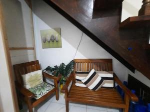 プエルト・プリンセサにあるLa Vida Hostelの階段付きのお部屋内の木製ベンチ2台