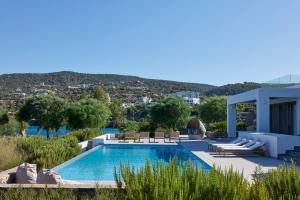 a villa with a swimming pool and a house at H2O Art Beach Villa Crete in Agios Nikolaos