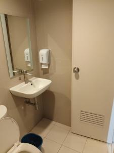 a bathroom with a sink and a toilet at Hotel Sogo Avenida in Manila