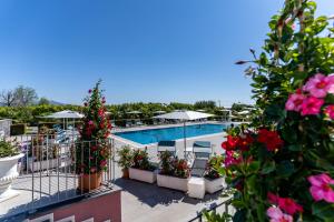a view of the pool at a resort with flowers at Dipladenia Garden Country Resort in Mascali