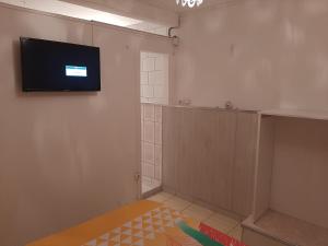 a room with a flat screen tv on a wall at Gites coeur des Antilles G in Trois-Rivières