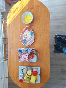 a wooden table with food on top of it at Mill House Apartment and Camping in Ljutomer