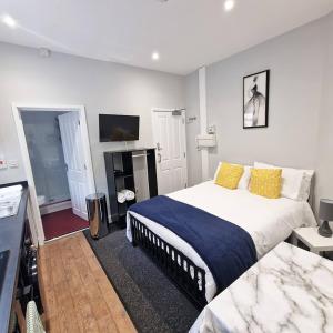 a bedroom with a large bed and a television at Stay Norwich Apartments Riverside House Apart-3 in Norwich