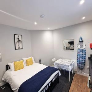 a bedroom with a bed and a table in it at Stay Norwich Apartments Riverside House Apart-3 in Norwich