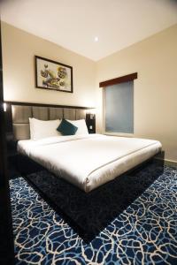 Postel nebo postele na pokoji v ubytování Naylover Hotel Suites