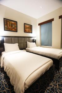 Postel nebo postele na pokoji v ubytování Naylover Hotel Suites
