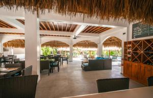 a restaurant with tables and chairs and a chalkboard at Secret Paradise Moalboal in Moalboal