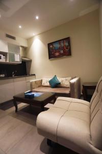 a living room with a couch and a table at Naylover Hotel Suites in Amman
