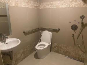 a bathroom with a toilet and a sink at Hotel Sogo Malate in Manila