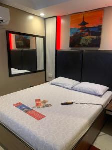 a bedroom with a large bed with a white mattress at Hotel Sogo Malate in Manila