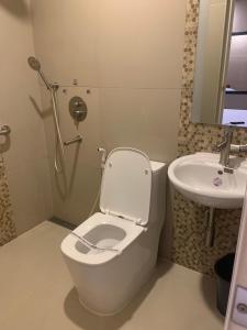a bathroom with a toilet and a sink at Hotel Sogo Malate in Manila