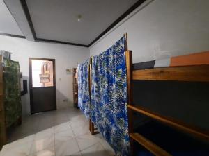 a room with a row of blue and white walls at La Vida Hostel in Puerto Princesa City