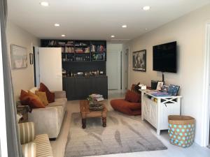 a living room with a couch and a tv at Villa @23 in Wanaka