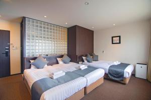 Voodi või voodid majutusasutuse WONZ HOTEL 島之内道顿堀心斎橋難波エリア中心地 New Open Sale toas