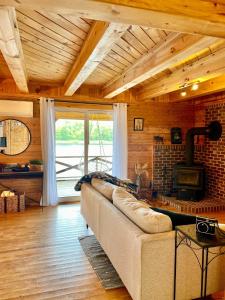 a living room with a couch and a fireplace at Knotty Pines 4 Bedroom with Waterfront Views in Chelmsford