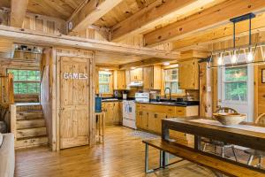 a kitchen with wooden cabinets and a table in a cabin at Knotty Pines 4 Bedroom with Waterfront Views in Chelmsford +102 photos
