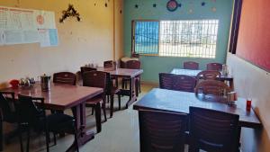 a dining room with tables and chairs in a restaurant at BEACH STAYs in Revadanda