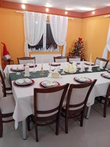a dining room with a table and a christmas tree at CASA GRIDE in Tohanu Nou
