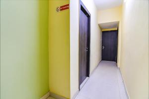 an empty hallway with a door and a hallway sidx sidx at FabHotel Eco Inn in kolkata