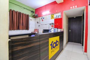 a fast food restaurant with a yellow sign on a counter at FabHotel Eco Inn in kolkata