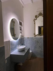 a bathroom with a sink and a mirror at Ascanio Twenty Six in Rome