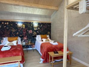 a bedroom with two beds with red sheets at Castaños - Casal do Conde in Caldas de Reis +27 photos