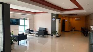 a lobby of a hospital with chairs and tables at Hotel Sogo Bacoor in Bacoor +8 photos