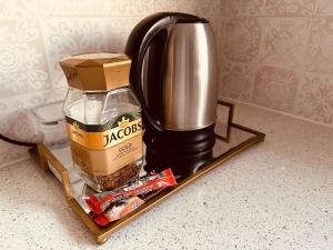 a coffee maker on a shelf with a box and food at Shepherds Inn in Boksburg