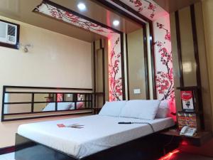 Postel nebo postele na pokoji v ubytování Hotel Sogo Edsa Caloocan