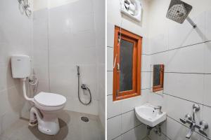 a bathroom with a toilet and a sink at FabHotel Siya Bihari in Ayodhya