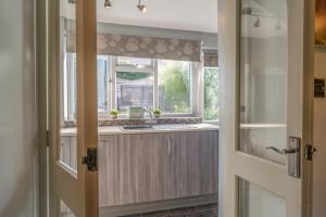 a kitchen with a sink and a window at L'al Cottage, Sockbridge in Penrith +22 photos