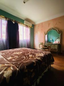 a bedroom with a large bed and a mirror at Luxurious apartment, 5K Premium Housing! in Az Zaqāzīq +15 photos