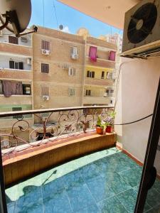 a balcony with a swimming pool on a building at luxurious apartment in Az Zaqāzīq