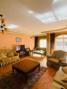 a living room with couches and a coffee table at Luxurious apartment, 5K premium housing! in Az Zaqāzīq +15 photos
