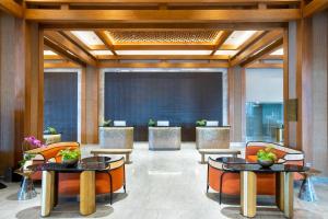a lobby of a hotel with tables and chairs at MORAZEN Yogyakarta in Temon