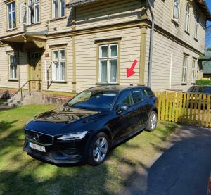 a black car parked in front of a house at Esplanaadi Luxury Apartment in Pärnu