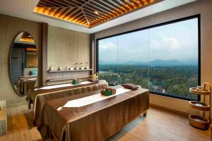 a large bathroom with two beds and a large window at MORAZEN Yogyakarta in Temon