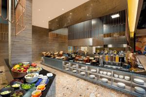 a buffet line with food in a restaurant at MORAZEN Yogyakarta in Temon