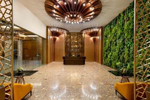 a lobby of a hotel with a green wall at MORAZEN Yogyakarta in Temon