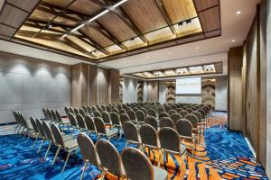 a conference room with rows of chairs and a stage at MORAZEN Yogyakarta in Temon