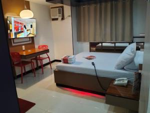 Postel nebo postele na pokoji v ubytování Hotel Sogo Banawe