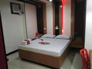 Ένα ή περισσότερα κρεβάτια σε δωμάτιο στο Hotel Sogo Banawe
