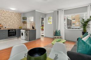 a living room with a couch and a table at The Crazy Central in Cape Town