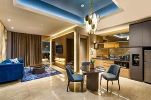 a kitchen and living room with a blue ceiling at MORAZEN Yogyakarta in Temon