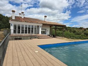 a house with a swimming pool in front of a house at Finca Altair in Madrid