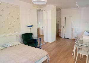 a bedroom with a bed and a glass table at Puck Nexo apartament u Doroty 2os in Puck