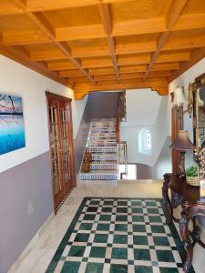 a living room with a checkered floor and stairs at Casa Pozuelo in Taramay
