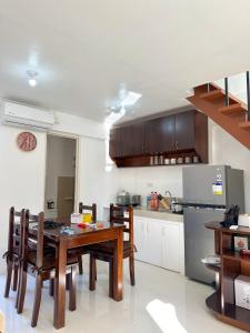 a kitchen with a table and chairs and a refrigerator at Palawan Homestay in Puerto Princesa City