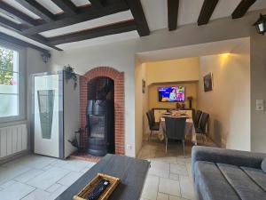 a living room with a table and a fireplace at Le Vinci /Maison près du château in Amboise