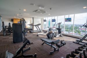 City Rise Hotel Miri في ميري: صالة ألعاب رياضية مع أجهزةالجري والتمرين في مبنى
